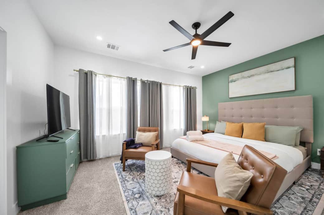 A plush king-size bed with an oversized tufted headboard is layered in crisp white linens, sumptuous throws, and a curated selection of designer pillows, blackout curtains, ensuring a restful night’s sleep. A plush king-size bed with an oversized tufted headboard is layered in crisp white linens, sumptuous throws, and a curated selection of designer pillows, blackout curtains, ensuring a restful night’s sleep.