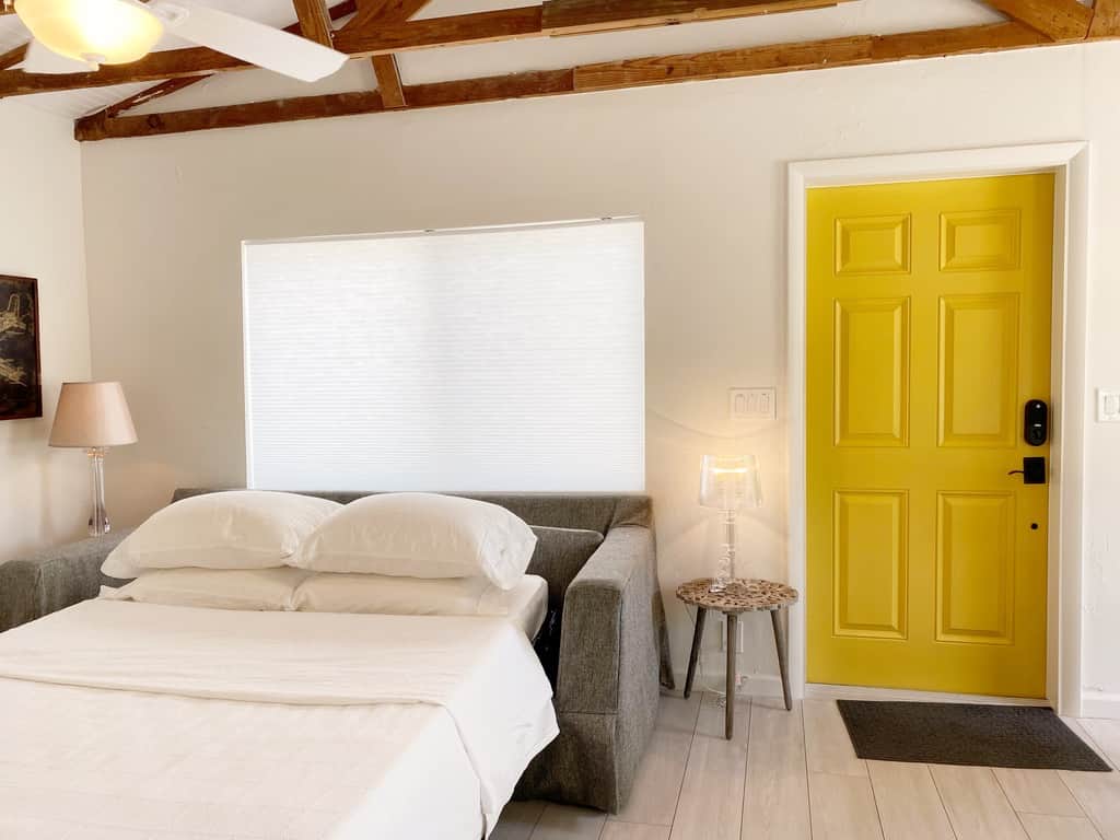 Bright renovated living room in Unit 2 at Casa Citron with impact windows, central AC, modern lighting, and a sofa bed for flexible guest comfort.