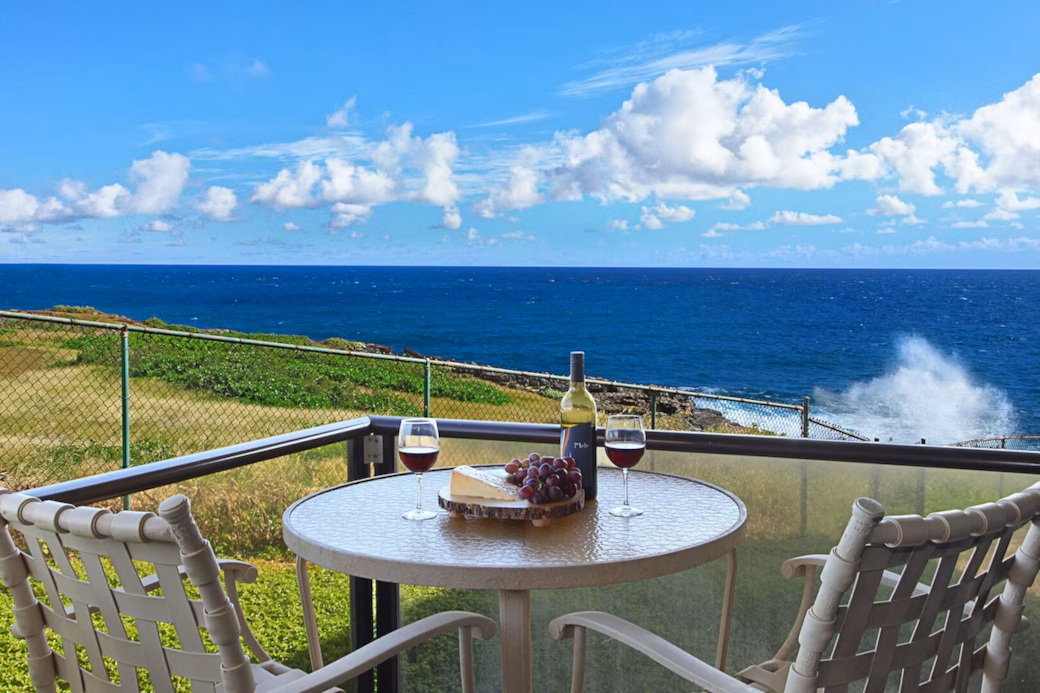 Furnished lanai with sweeping ocean and coastline views.