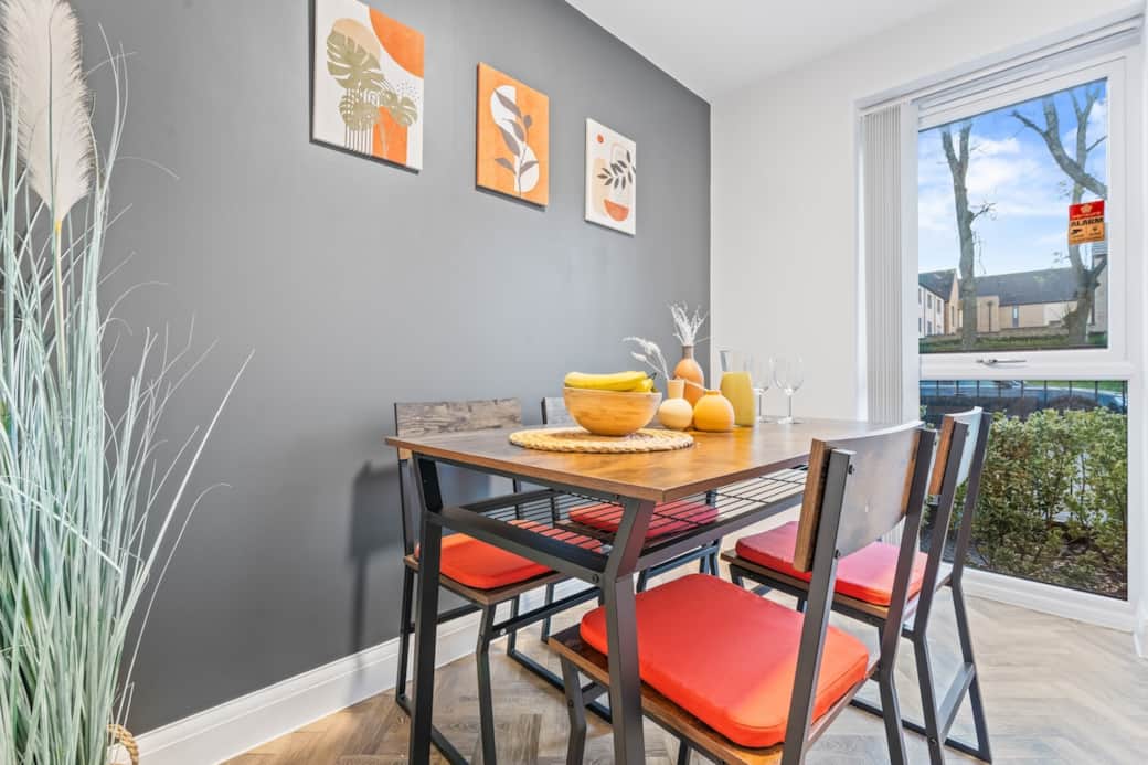 Enjoy meals in a light-filled dining area with garden views, warm accents, and a welcoming, contemporary feel.