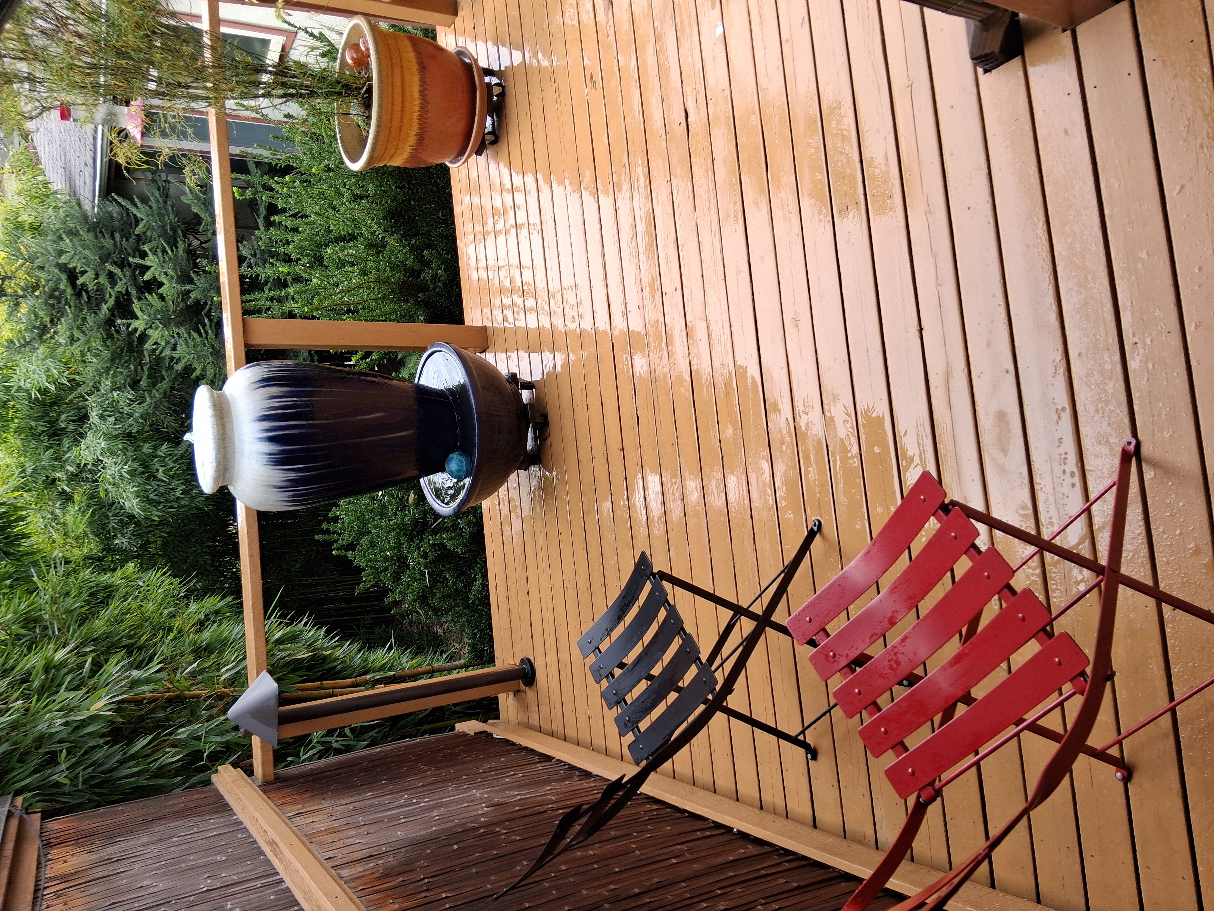 On the back deck, there is an overhang where you can stay dry and still enjoy the fresh air and back garden. We get hummingbirds at this fountain.