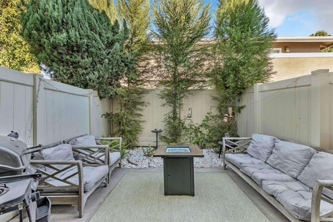 Bright and inviting, this patio is furnished with a comfy sofa, offering a cozy retreat to soak up the sunshine or stargaze at night.
