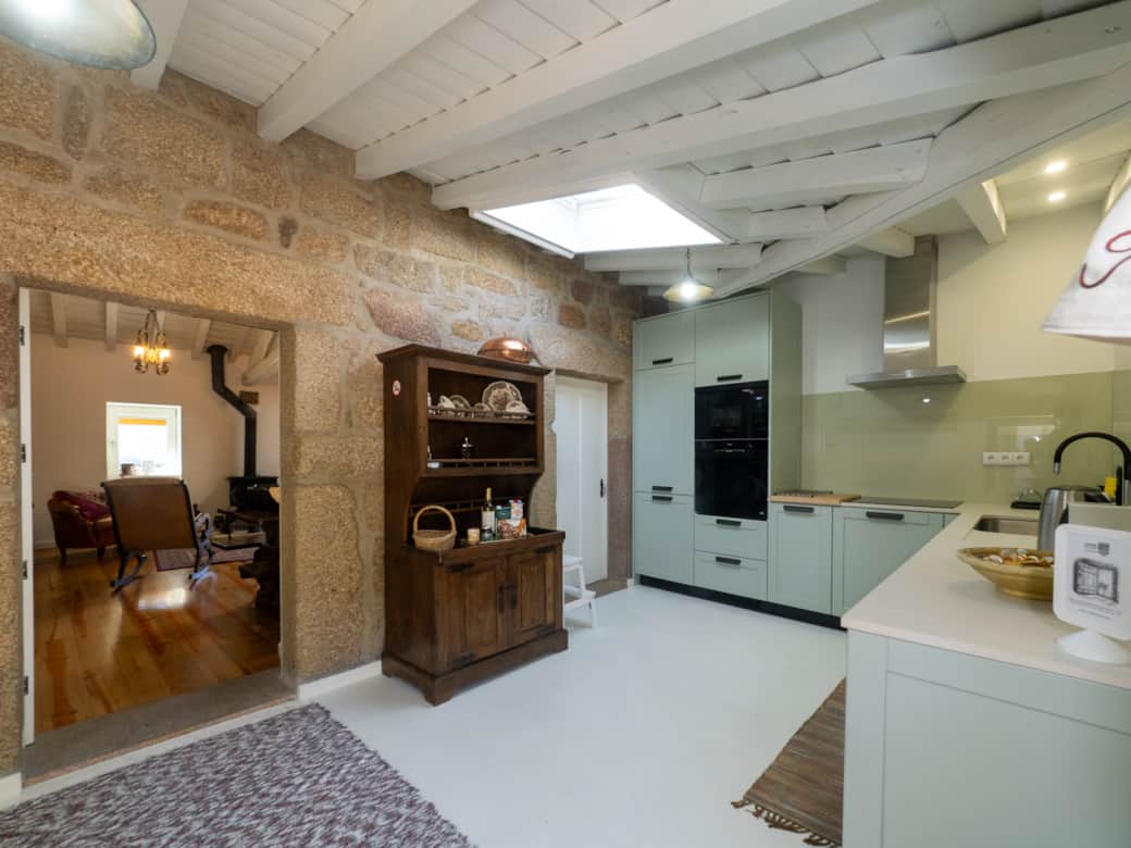 The modern kitchen connects to the living area, blending contemporary and traditional design.