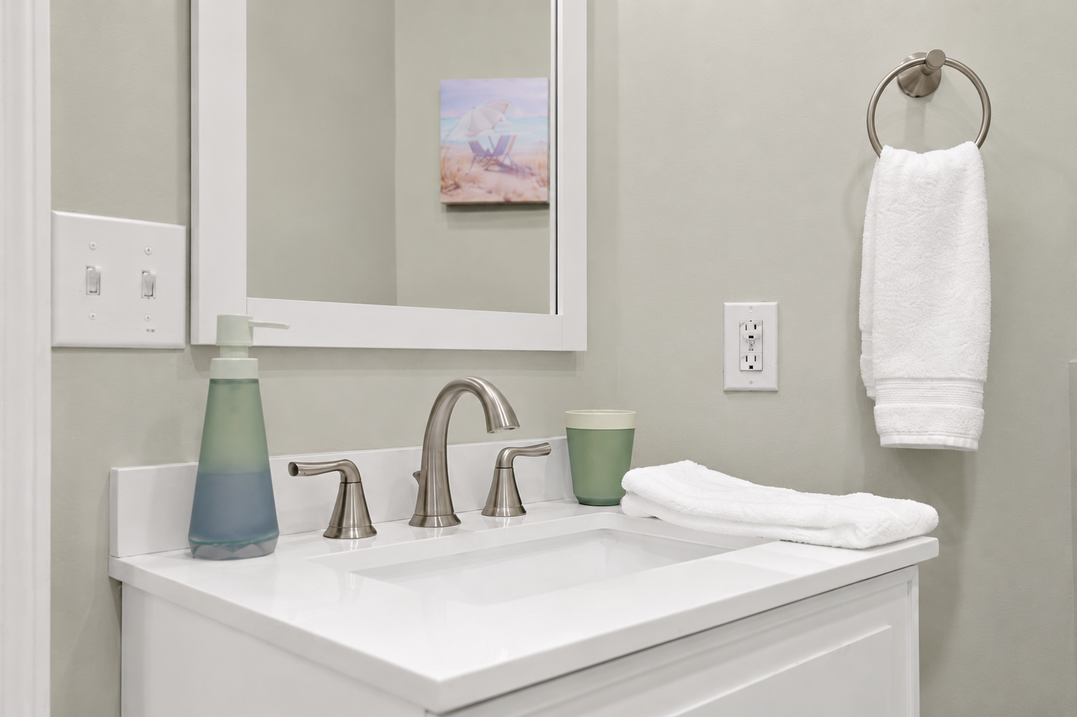 Freshen up at the sink with soap, a clean towel, and a mirror ready for your morning routine.