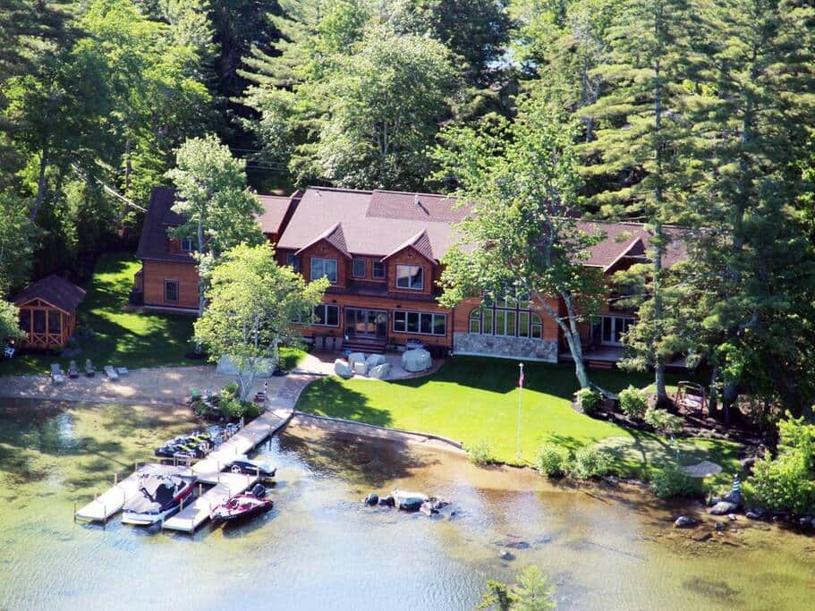 View of entire property featuring dock, sandy beach, putting green, gazebo and more.