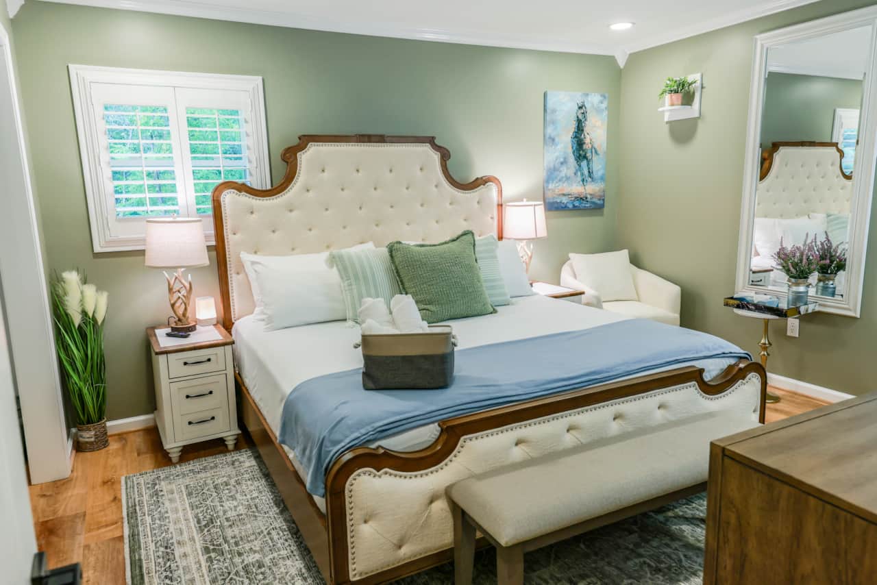 Master Bedroom with King Bed, work station, shutter blinds, and 55in TV