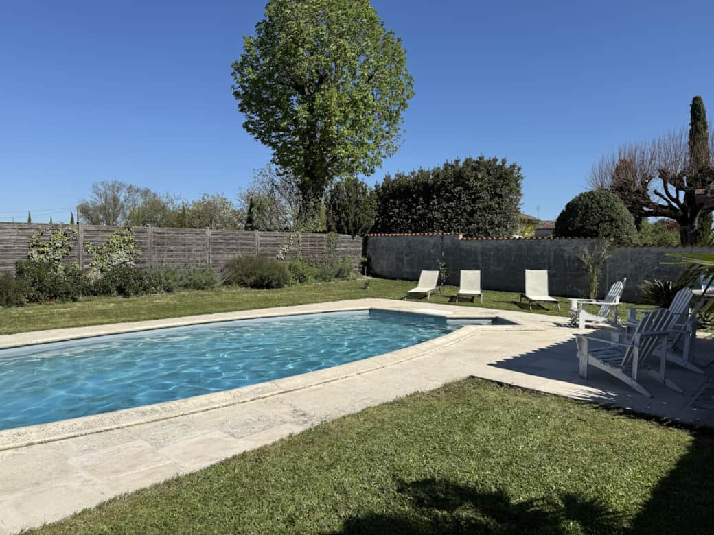 Private swimming pool with secure access and a pool house
