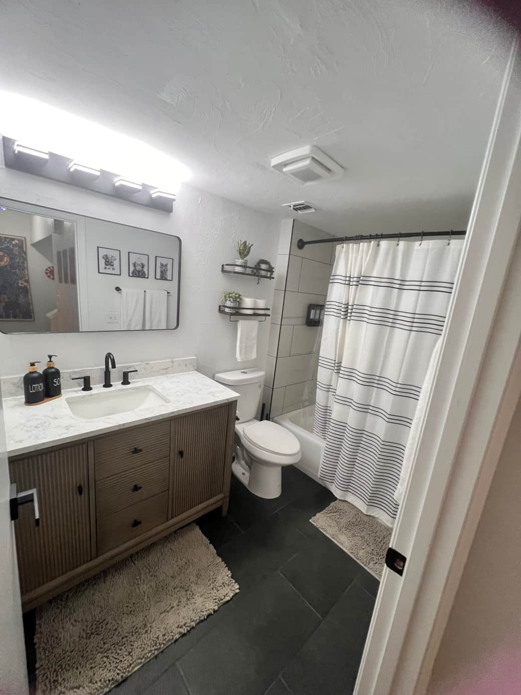 Kid-friendly full bath with soaking tub + fun black & white animal theme—splash time approved!