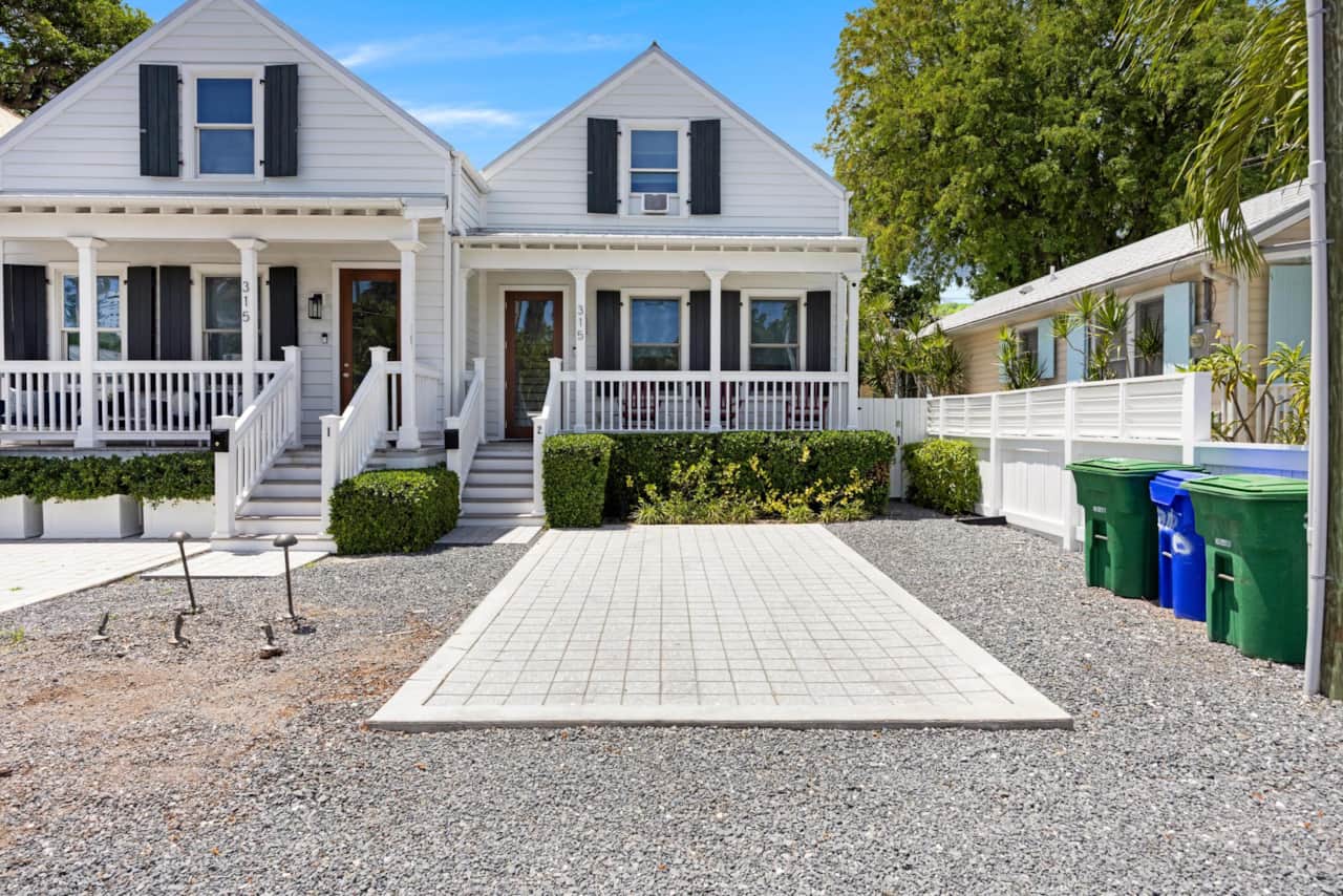 Charming white townhouse with inviting front porch, tucked away in beautiful Old Town.