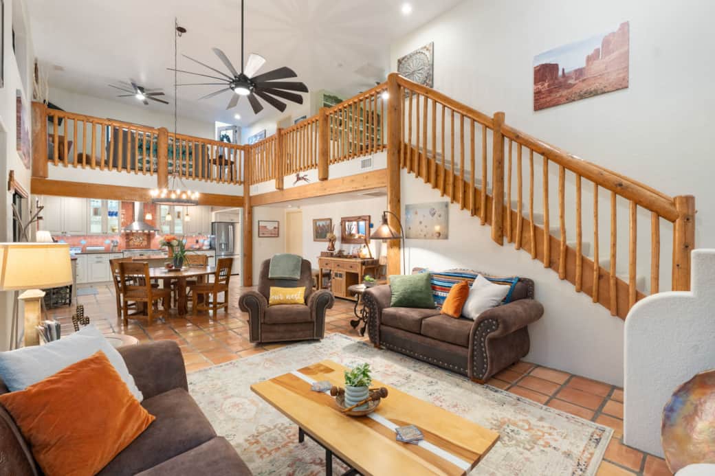 Open living and dining room with a two-story ceiling. Gourmet kitchen.