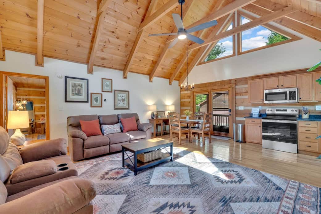 This open-concept living space features comfy reclining sofas, a spacious dining area, and plenty of natural light—perfect for gathering, relaxing, or enjoying a quiet night in after exploring the High Country. This open-concept living space features comfy reclining sofas, a spacious dining area, and plenty of natural light—perfect for gathering, relaxing, or enjoying a quiet night in after exploring the High Country.