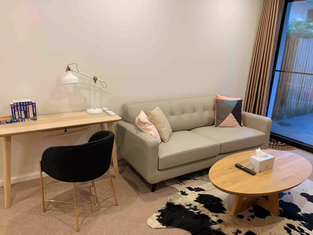 Our comfortable living room is designed for both relaxation and productivity. The plush sofa and inviting coffee table make it an ideal spot for lounging, while the desk with a lamp offers a dedicated workspace, making every moment here enjoyable.