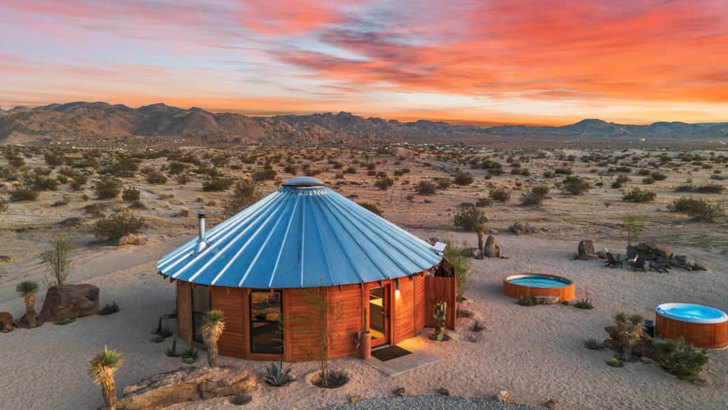 Mojave Yurt at golden hour — 30-ft solid-wood roundhouse on 25 private acres
