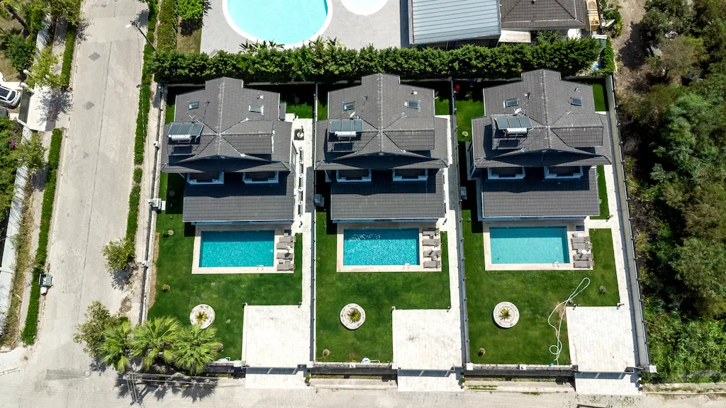 Aerial view of three villas with private pools and green lawns, Villa Palmiye B, Gocek.