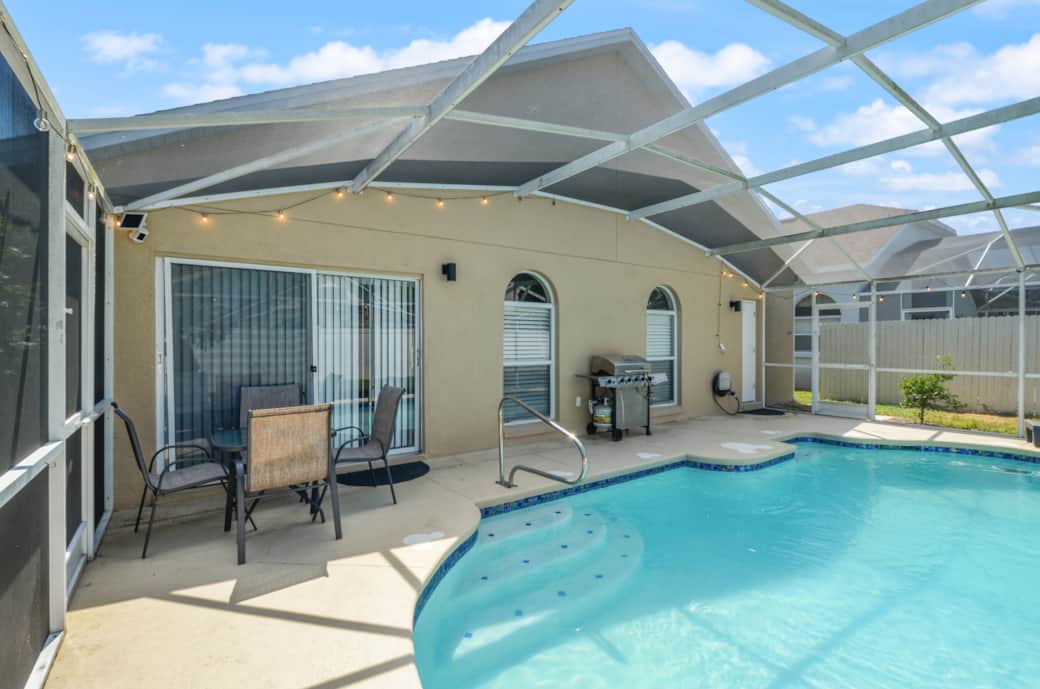 Relax in your private screened pool with lounge chairs, dining space & fun Mickey touches!