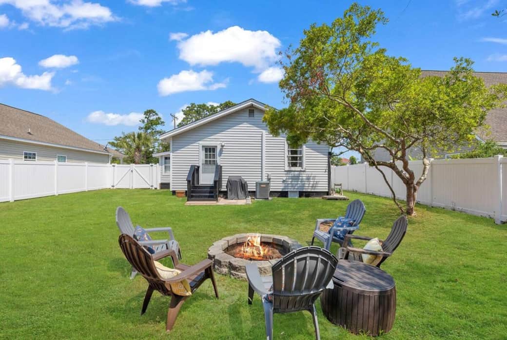 Fully fenced back yard with fire pit