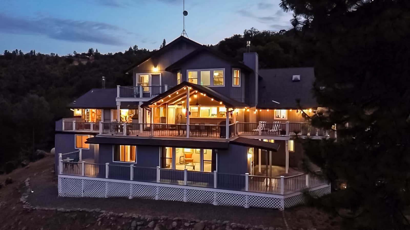 Mountain Daddies bed and breakfast glowing at dusk in Oakhurst near Yosemite