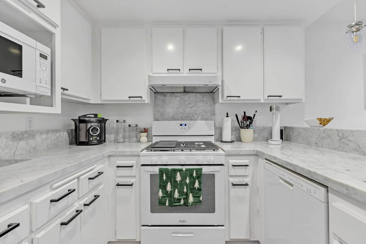 This thoughtfully designed kitchen has plenty of cabinets and modern appliances, giving you space and tools to cook up your favorite meals.