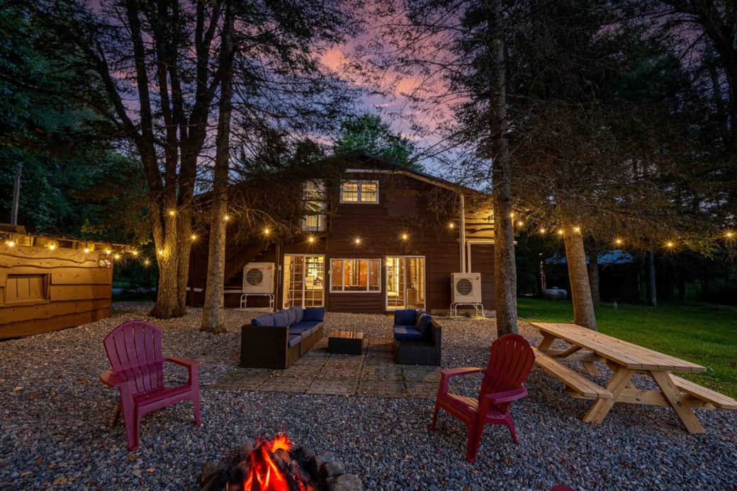 Back area with picnic table, firepit, and outdoor couch
