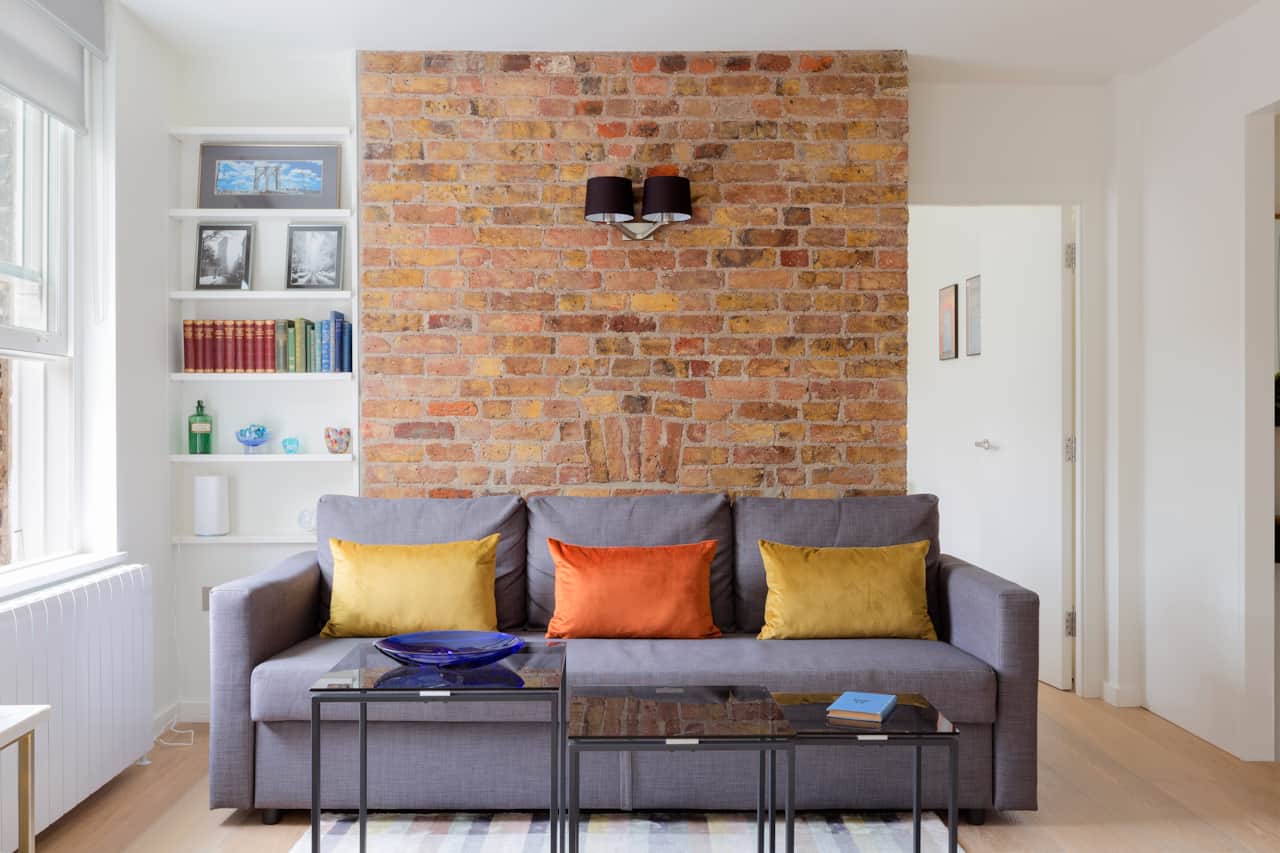 Cosy seating nook framed by an original exposed brick chimney breast