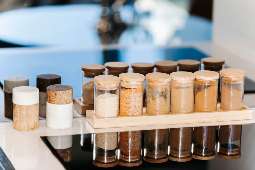 Options of salt and pepper, seasoning powder. Our kitchen boasts a spice rack filled with a variety of seasonings, ready to elevate your culinary creations. The neatly arranged jars are both functional and aesthetically pleasing.