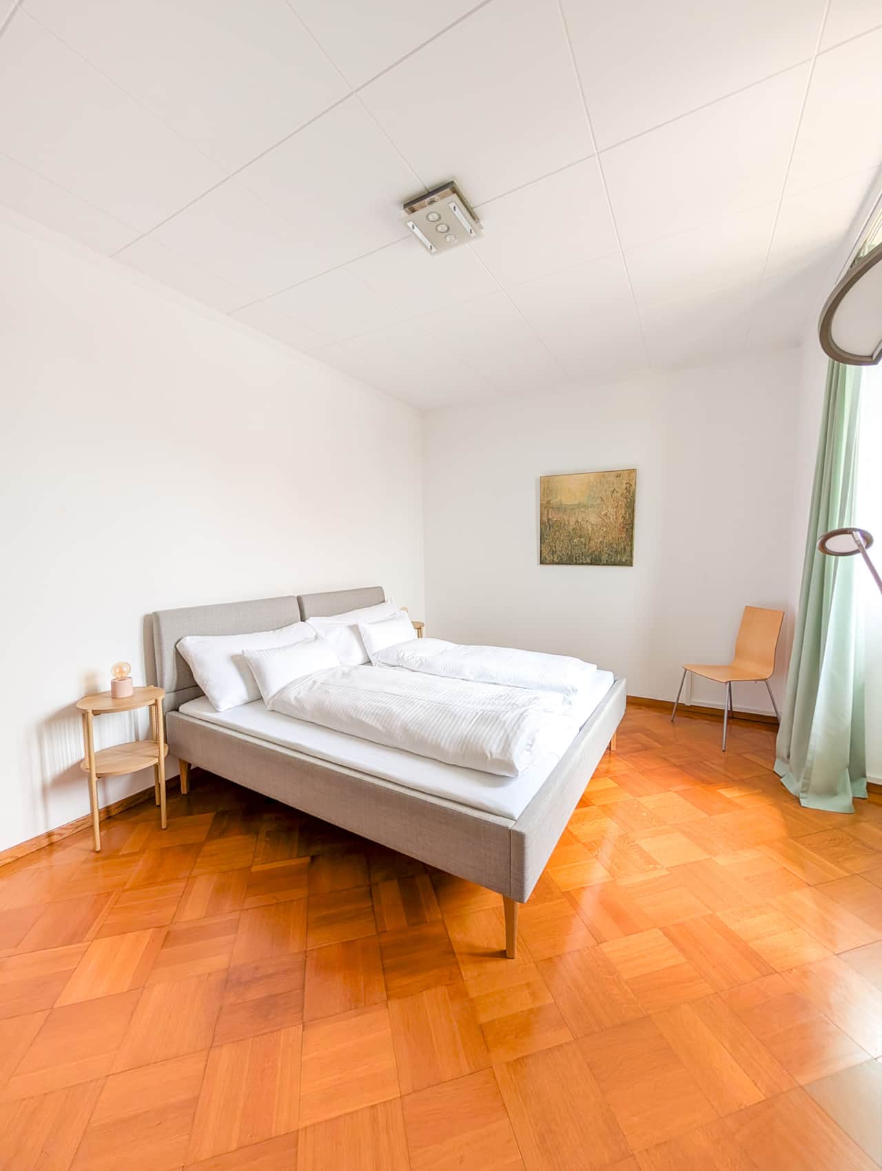 Spacious room with double bed and desk area.