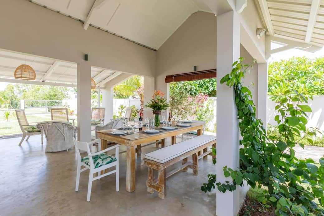 Outdoor living area with dining table and lounge area