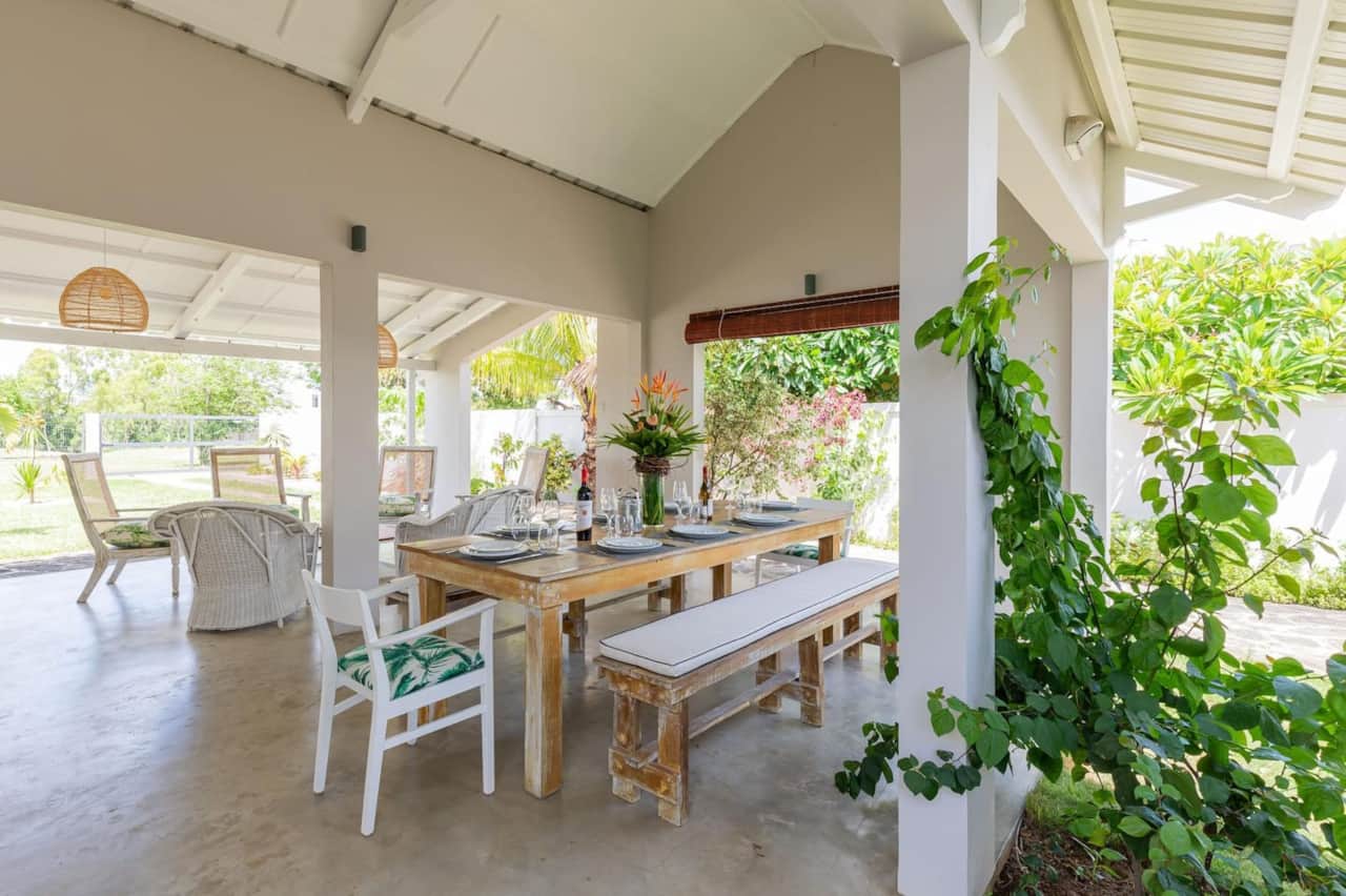 Outdoor living area with dining table and lounge area