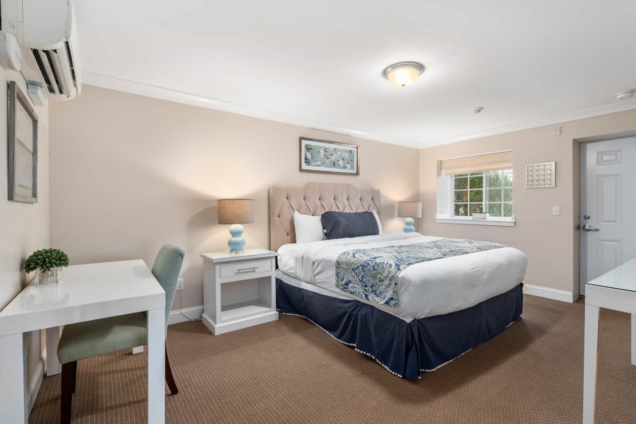 King bed with clean provided linens, private entrance, and a dedicated workspace