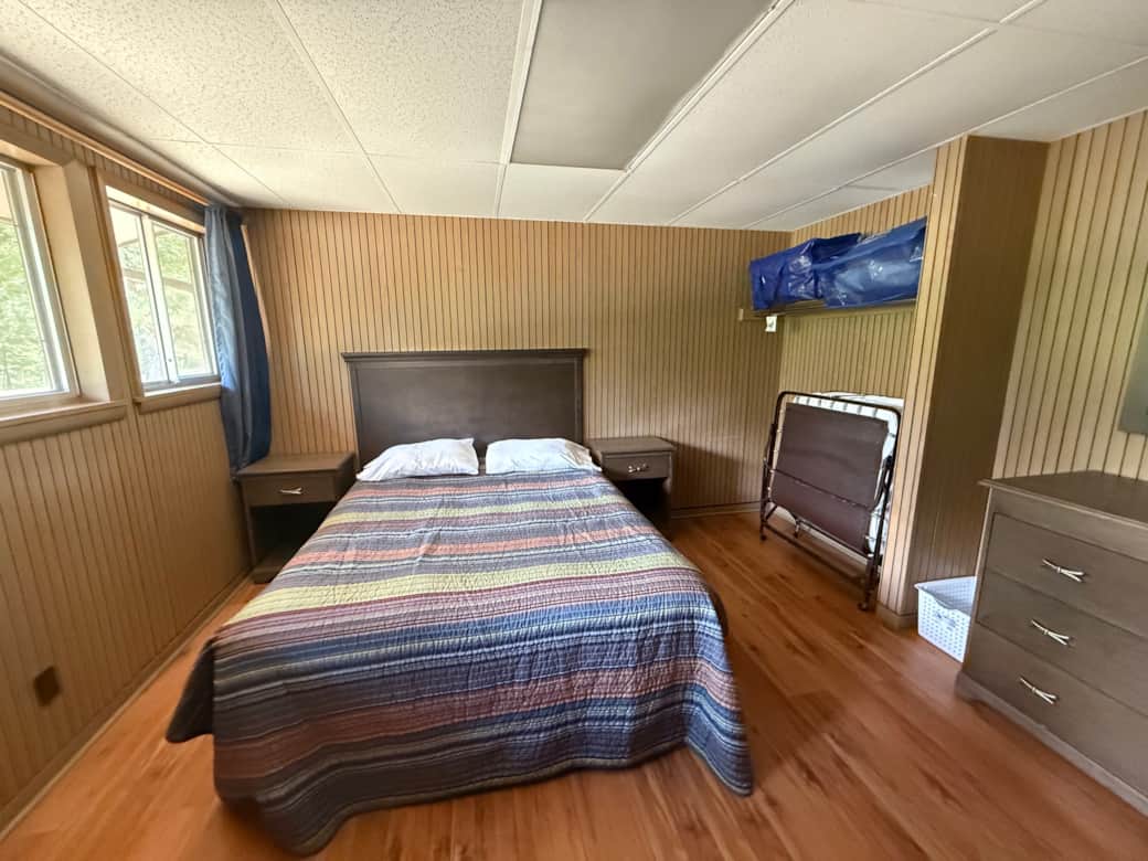 Cozy cabin bedroom with wood walls at Buffalo Point near Buffalo River
