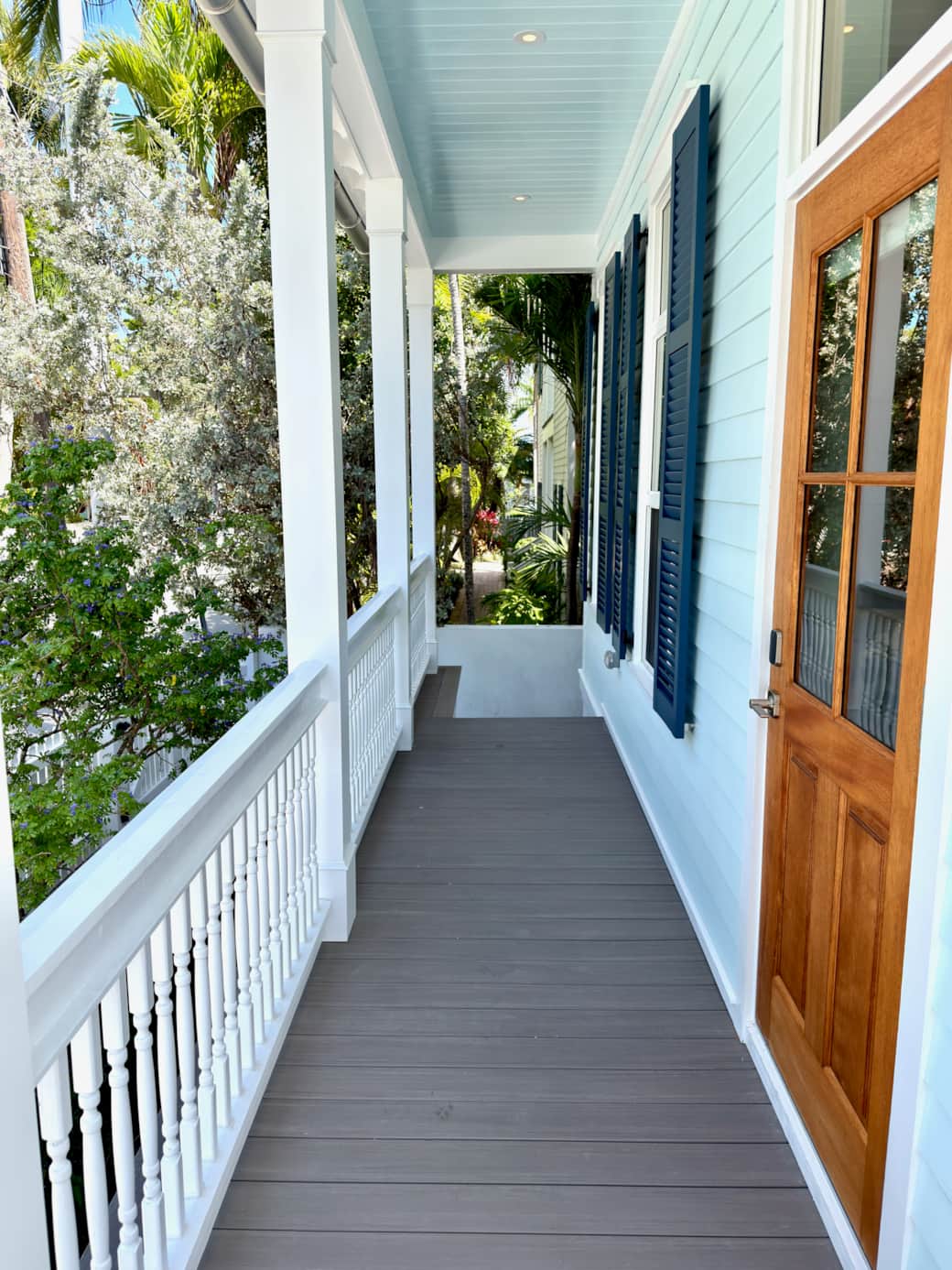 Classic Old Town Key West exterior with wraparound porches, tropical landscaping, and gated parking