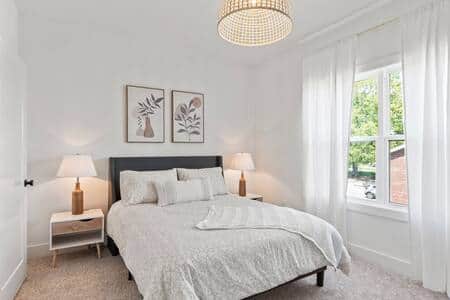 2nd floor bedroom with queen bed, walk in closet, TV and luggage rack.