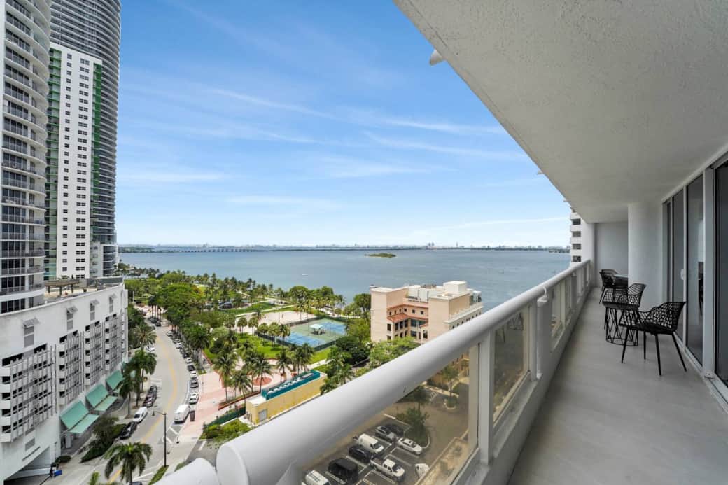 Furnished balcony with water views of Biscayne Bay and Margaret Pace Park