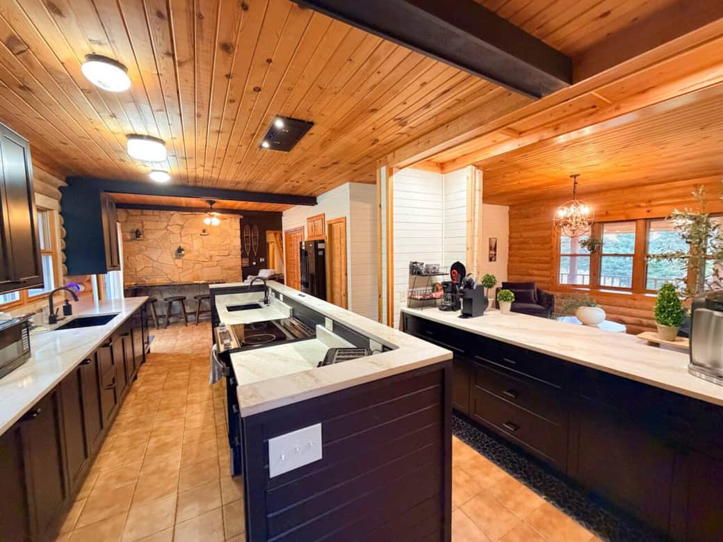 Fully renovated summer 2025 with all of the amenities you need.  Brand new range, oven, and fridge.  Custom marble counters and custom cabinetry with all of the basics needed for food prep and meals. Offering sliding door to porch, fire pit, hot tub.