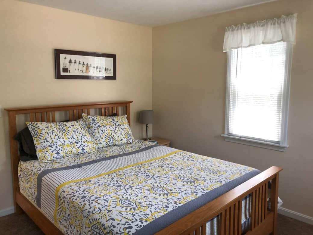 Bright first-floor bedroom with a comfortable queen bed and natural light, a cozy retreat for couples or family members during your Cape Cod stay. Bright first-floor bedroom with a comfortable queen bed and natural light, a cozy retreat for couples or family members during your Cape Cod stay.