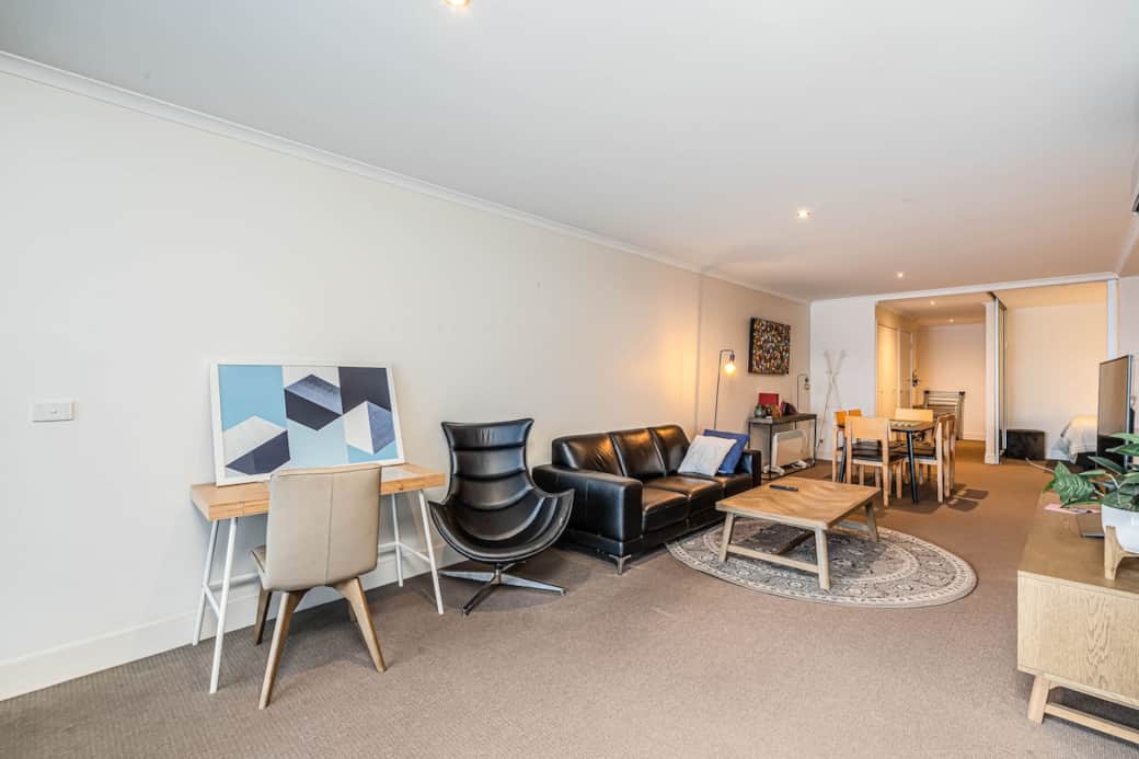 Step into the  living area, the dining table sets the stage for memorable meals, while the kitchenette allows for quick snacks. The modern decoration and ample natural light create an inviting atmosphere for socializing or simply enjoying a moment.