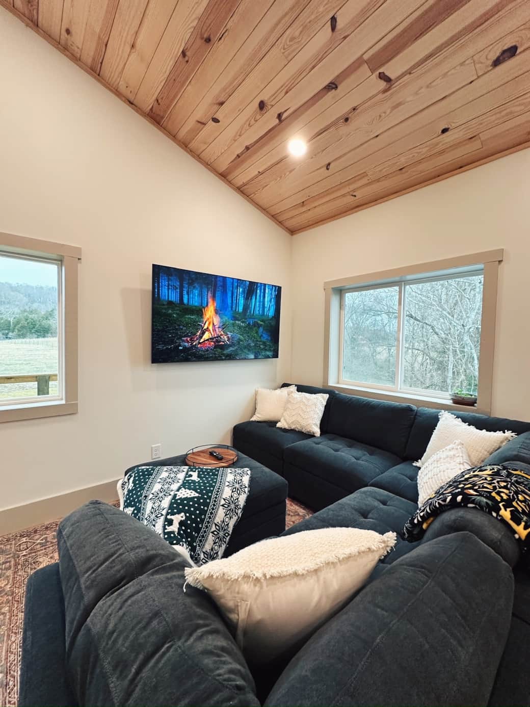 Cozy living room with large sectional, open floor plan, smart TV, windows that overlook farm Cozy living room with large sectional, open floor plan, smart TV, windows that overlook farm