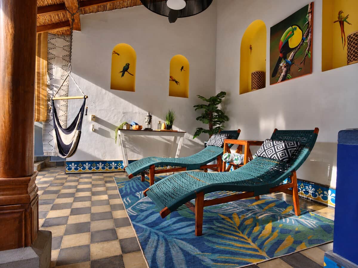 Unwind in your private open-air spa lounge with comfortable chaise lounges, yoga mats, artisan décor, and a self-serve coffee and tea station. A peaceful retreat designed for reading, relaxing, or enjoying Granada’s tropical climate after a day.