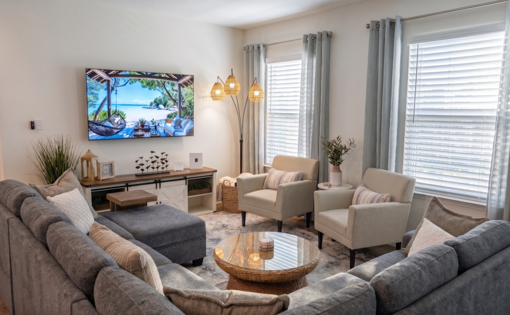 Bright open-concept living room flowing into kitchen & dining area.