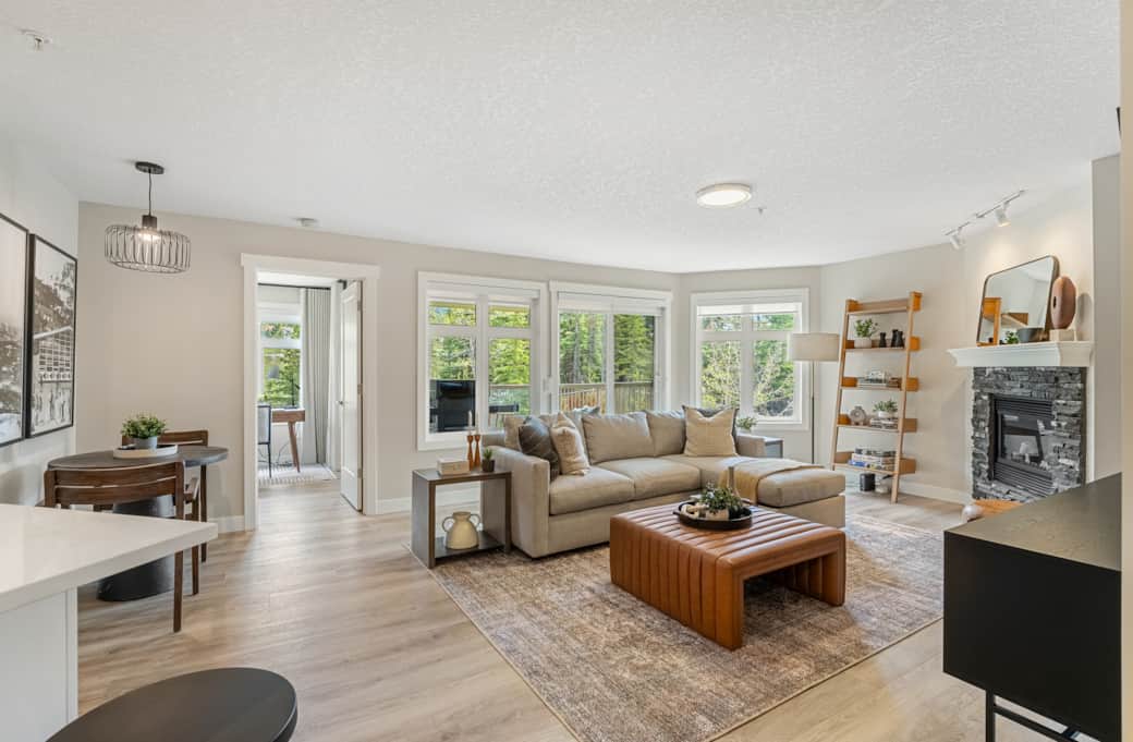 Great room with view of balcony and into primary bedrooom