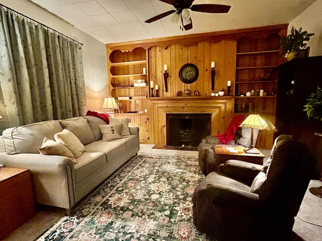 This room is SO cozy! Better yet it has a wood burning fireplace, a queen sofa sleeper, and wardrobes for clothing storage. It serves as a main floor 5th bedroom!