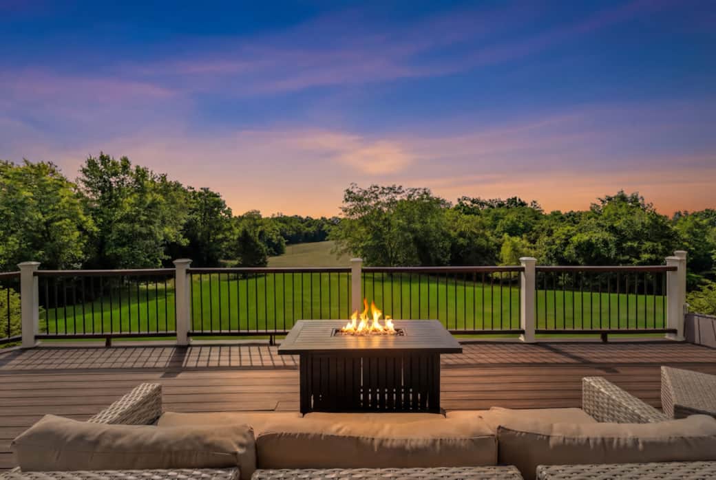 Relax on the deck by the fire table and enjoy stunning sunset views over open fields.