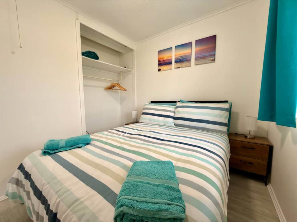 Comfortable double bedroom with fresh linen and storage