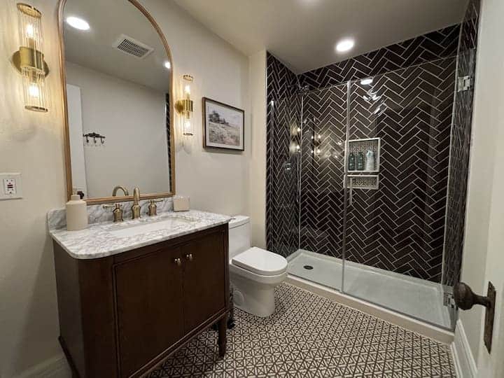Beautifully updated bathroom featuring a marble vanity, modern fixtures.