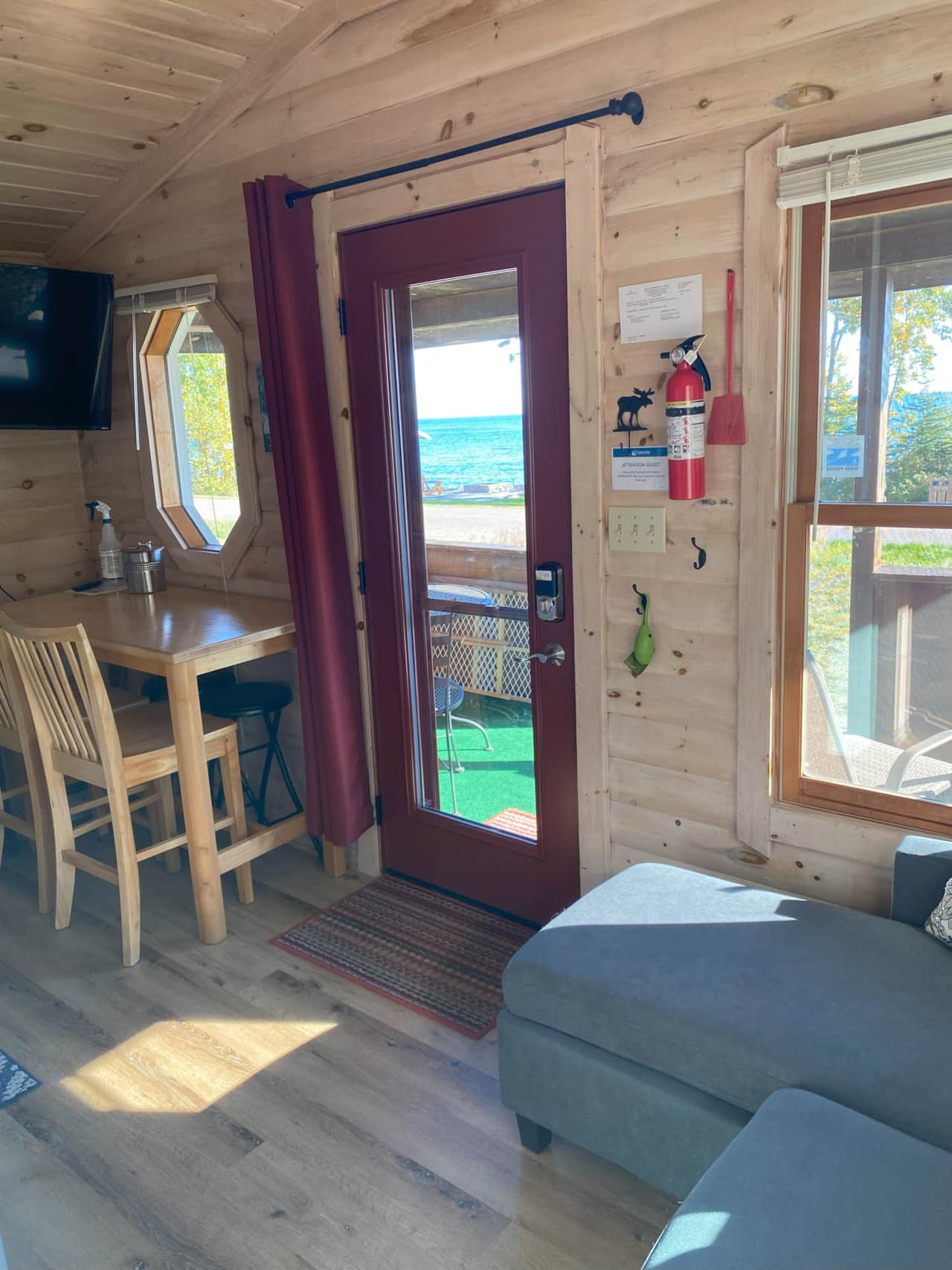 Full glass front door to enjoy your Lake views. Note the privacy curtain tucked by the table