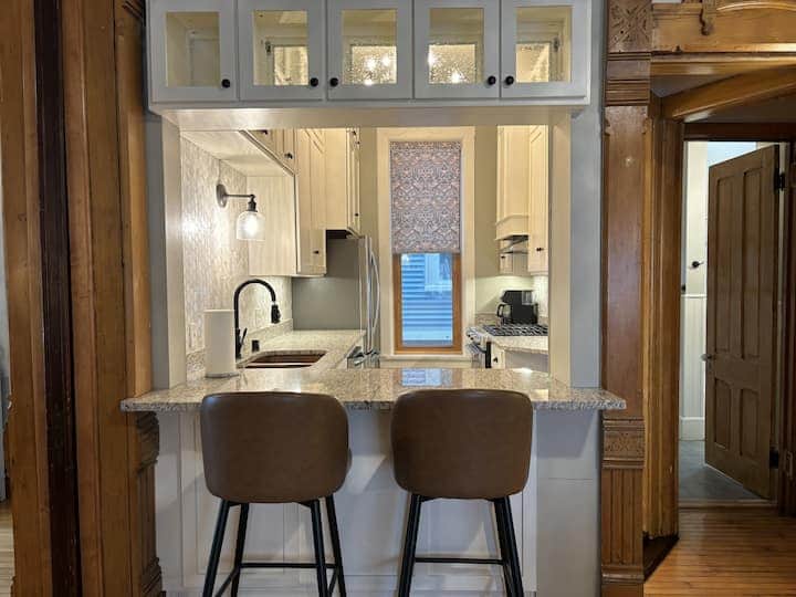 Bright, updated kitchen featuring granite countertops, stainless steel appliances