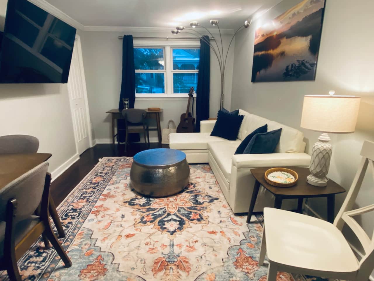 Modern comfort meets charm — cozy living space with local art and a 55” smart TV 🎨🛋️
