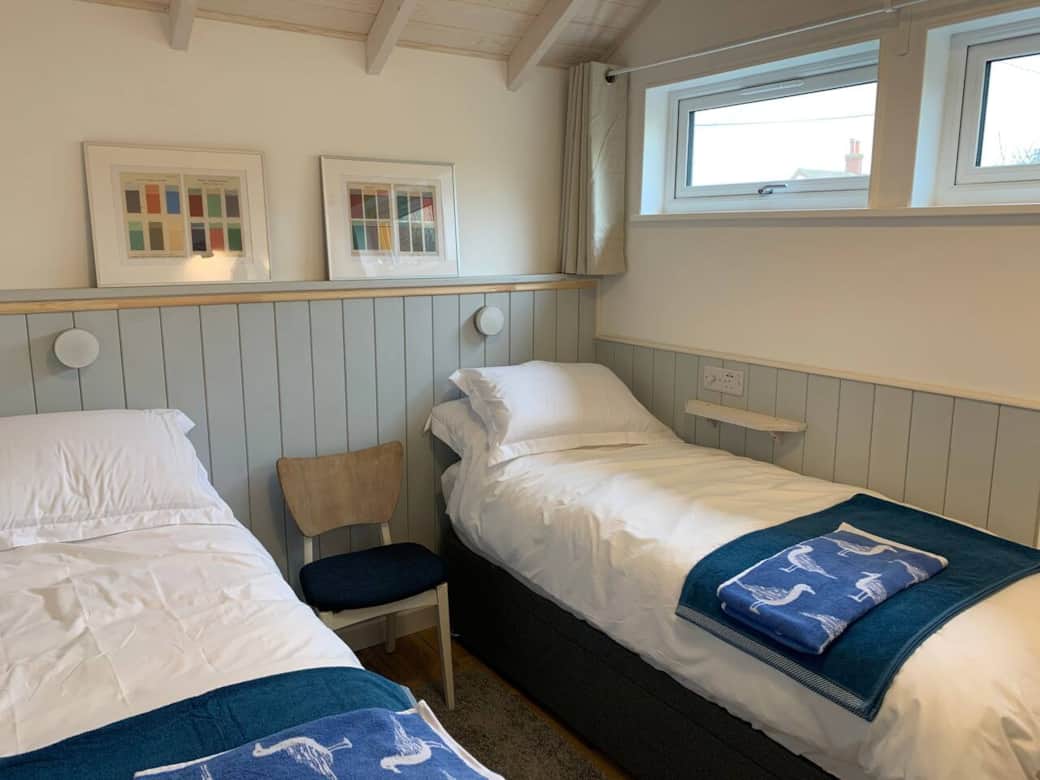 Bedroom two is called the Cabin Room and is super cosy. There are blinds and curtains so if you need a darker room for children to sleep then this is perfect. These beds can come together to make a kingsized bed on request. Bedroom two is called the Cabin Room and is super cosy. There are blinds and curtains so if you need a darker room for children to sleep then this is perfect. These beds can come together to make a kingsized bed on request.