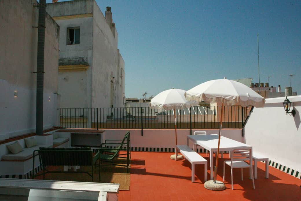 The rooftop has a lounge area with a built-in bench/table, as well as HAY design chairs and bench. On the other side, a long dining table with umbrellas offer shade for groups to enjoy a meal on the terrace. Design and comfort is what inspired us!