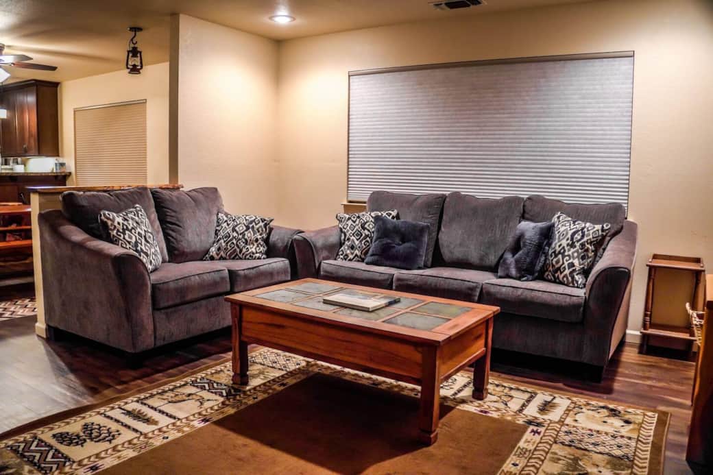 A comfortable living area with couches, a coffee table, a charging area to charge your devices, board games, and a large 4k TV. You'll never have a dull moment with your guests in this space.